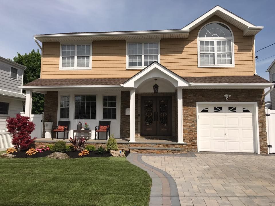 The front of a house with a white garage door