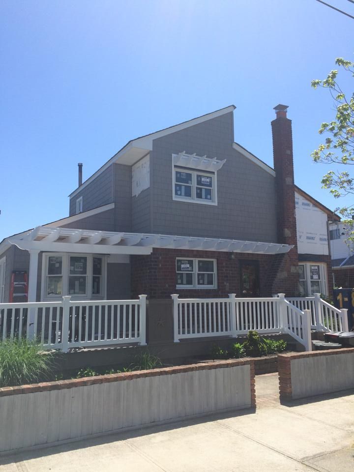 A house with a white fence and a chimney