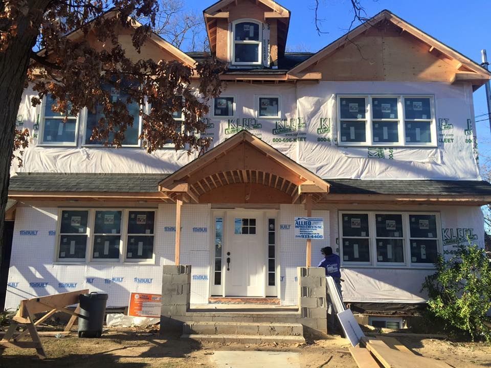 A house that is being built with a lot of windows