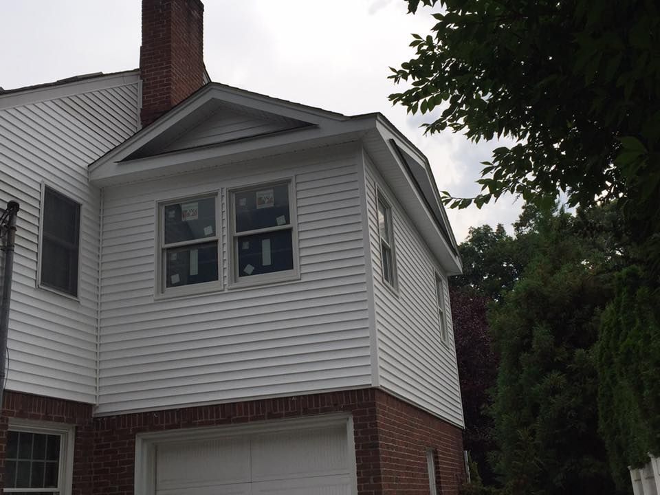 A white house with a garage and a chimney