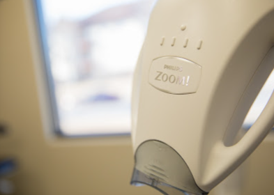 A close up of a zoom tooth whitening device
