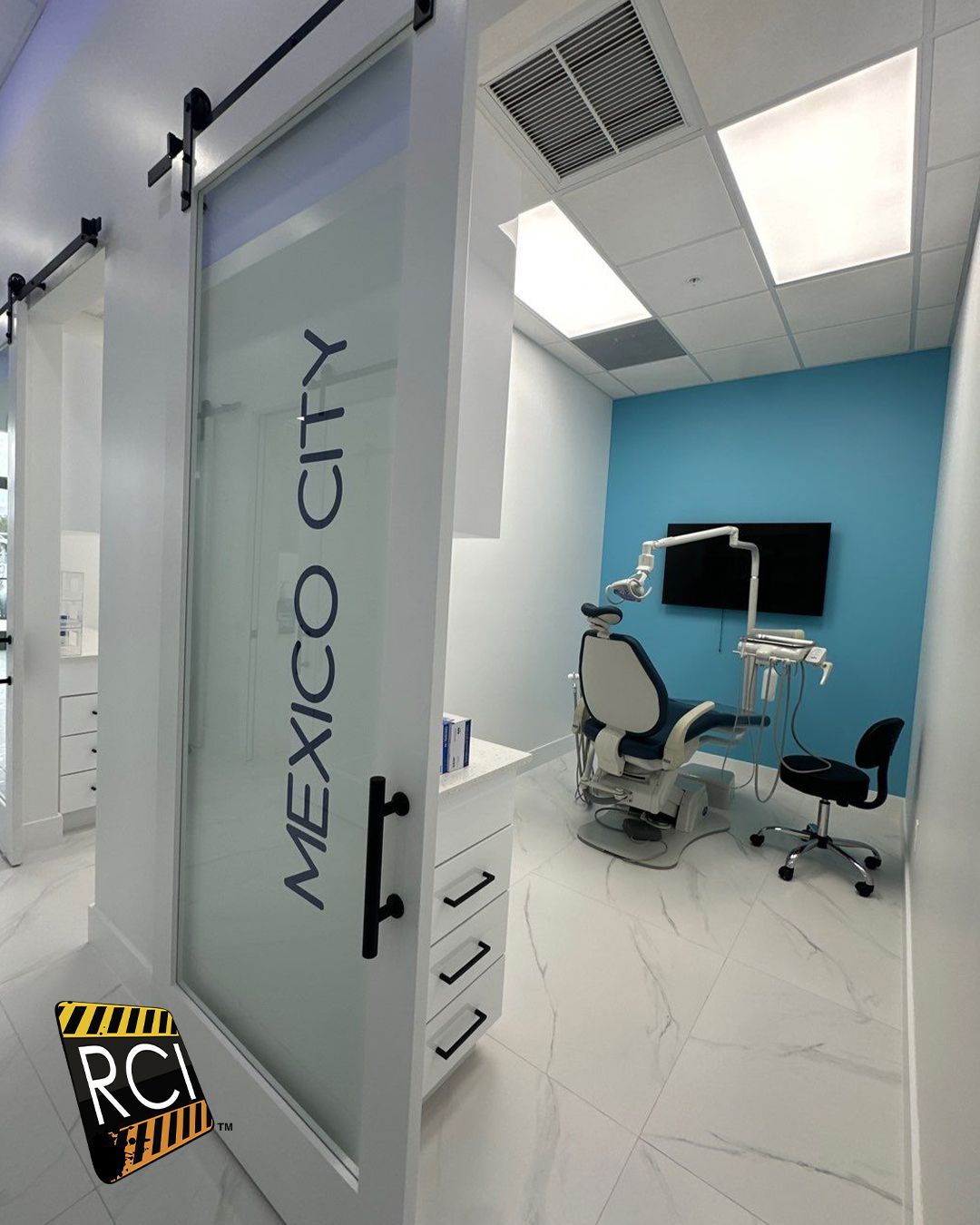 A dental office with a sliding barn door that says mexico city