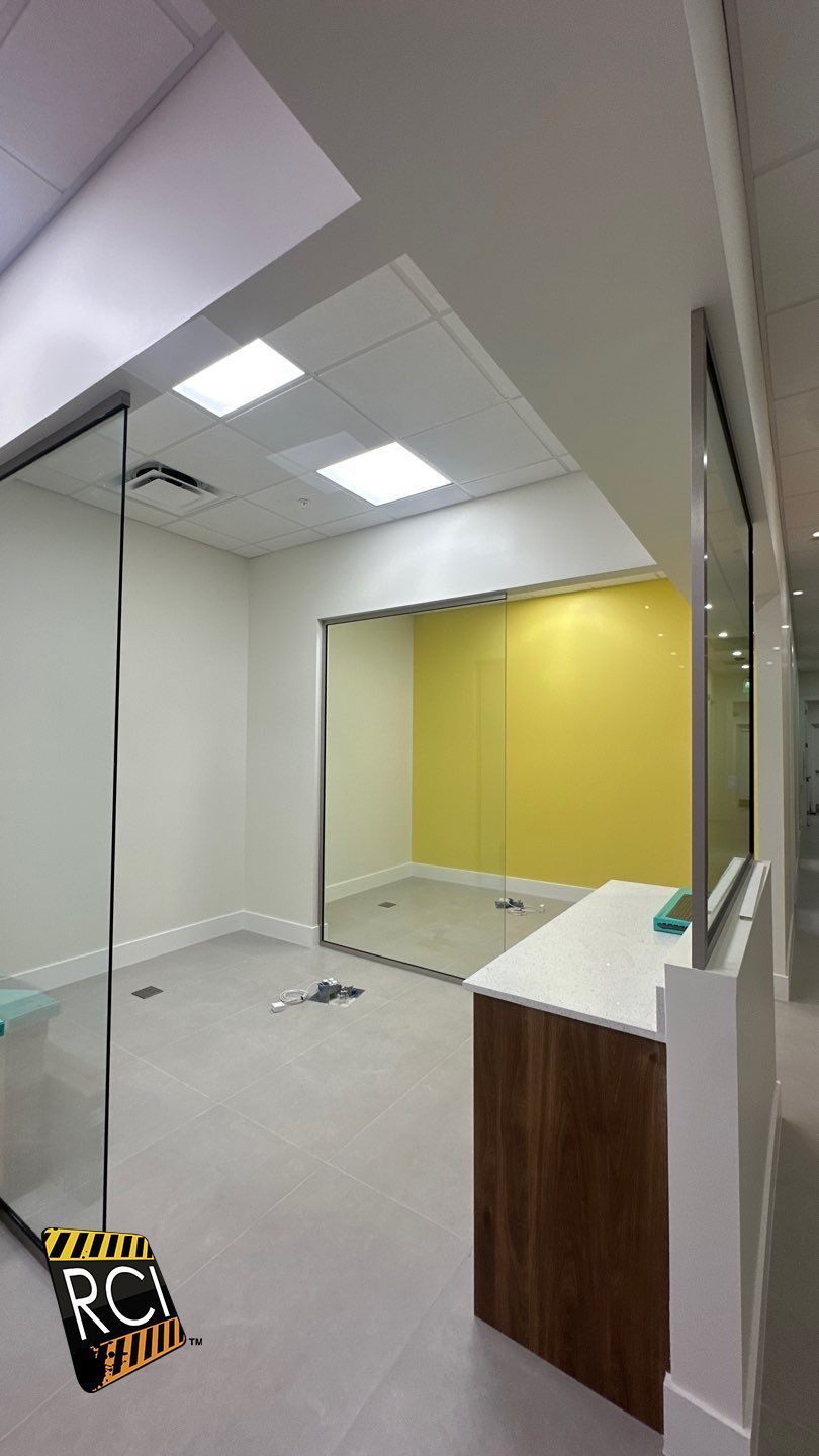 An empty room with a yellow wall and a wooden counter.