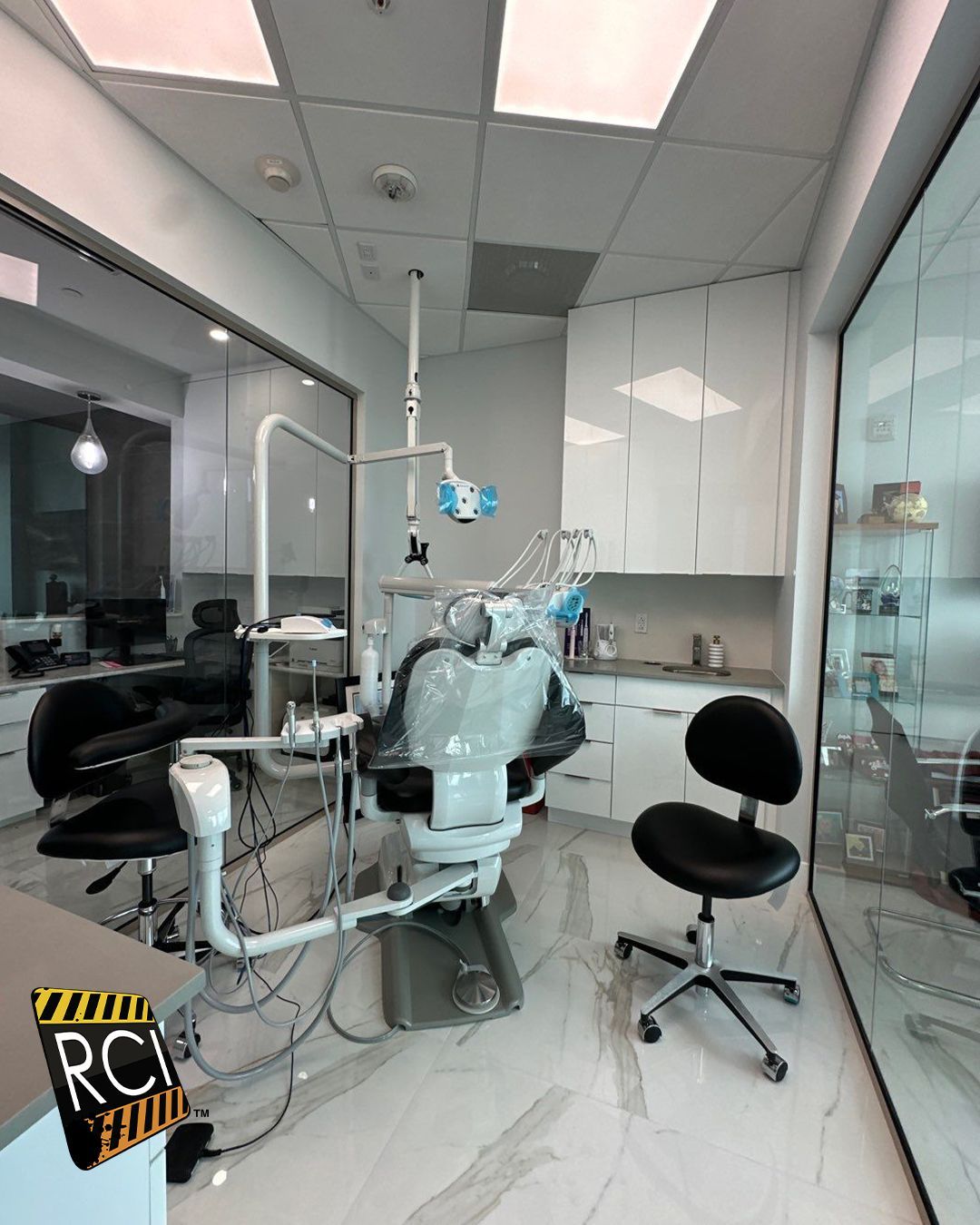 A dental office with a dental chair and chairs
