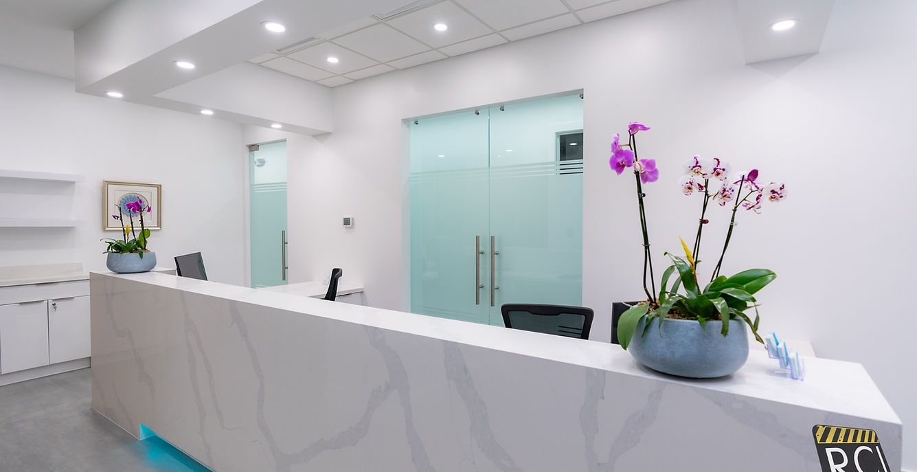 A reception desk in a dental office with flowers on it.