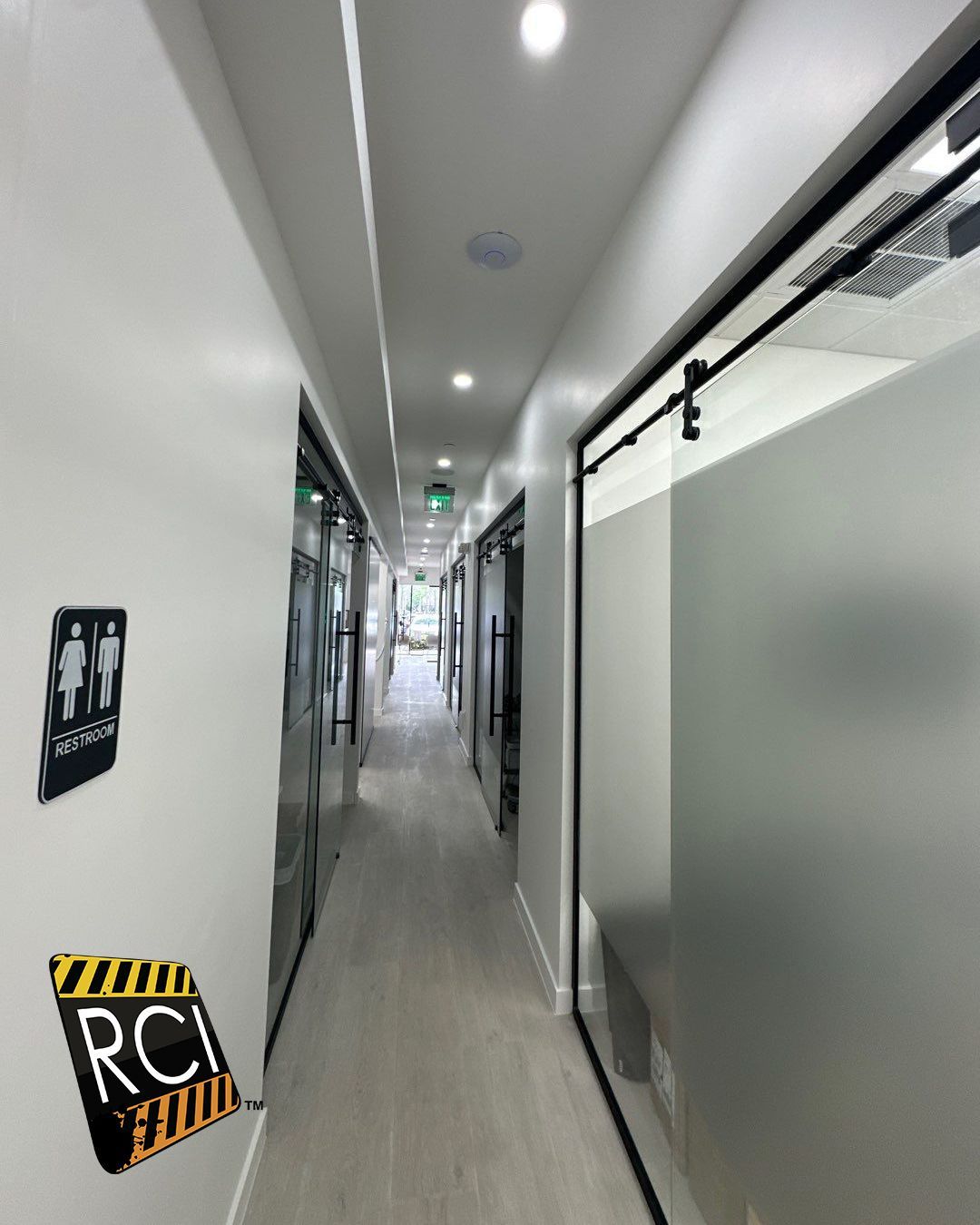 A long hallway with a sign on the wall that says rci