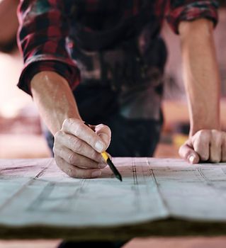 A person is writing on a piece of paper with a pen.