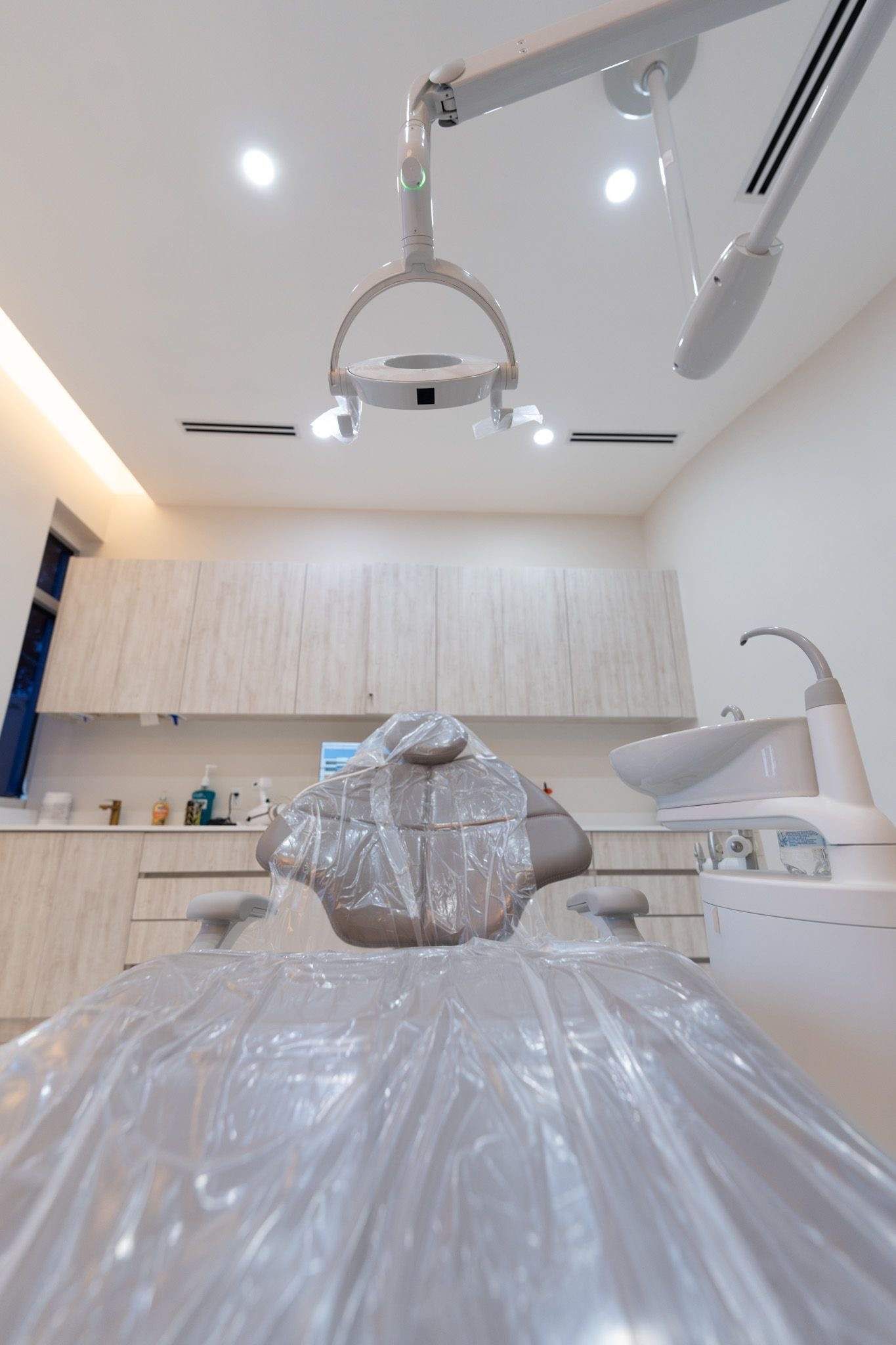A dental office with a dental chair and a computer.