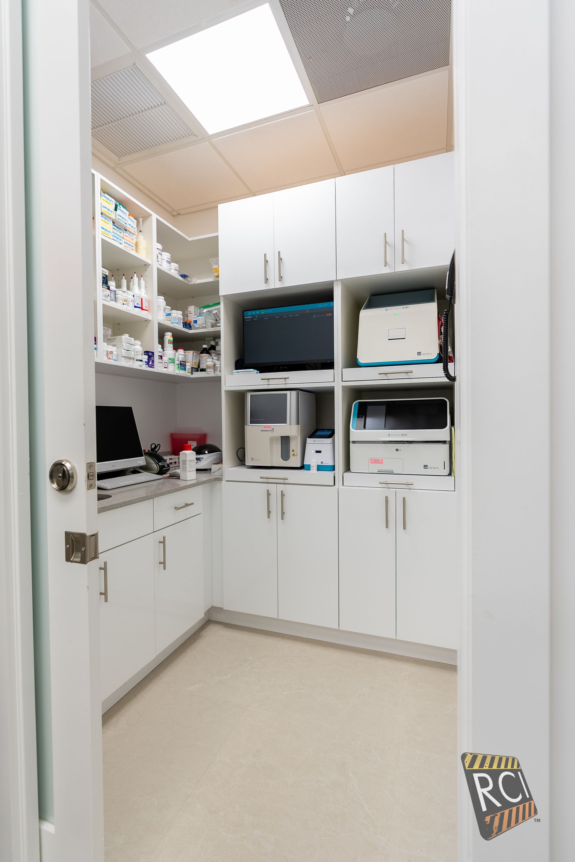A room with a lot of shelves and cabinets and a door that is open.