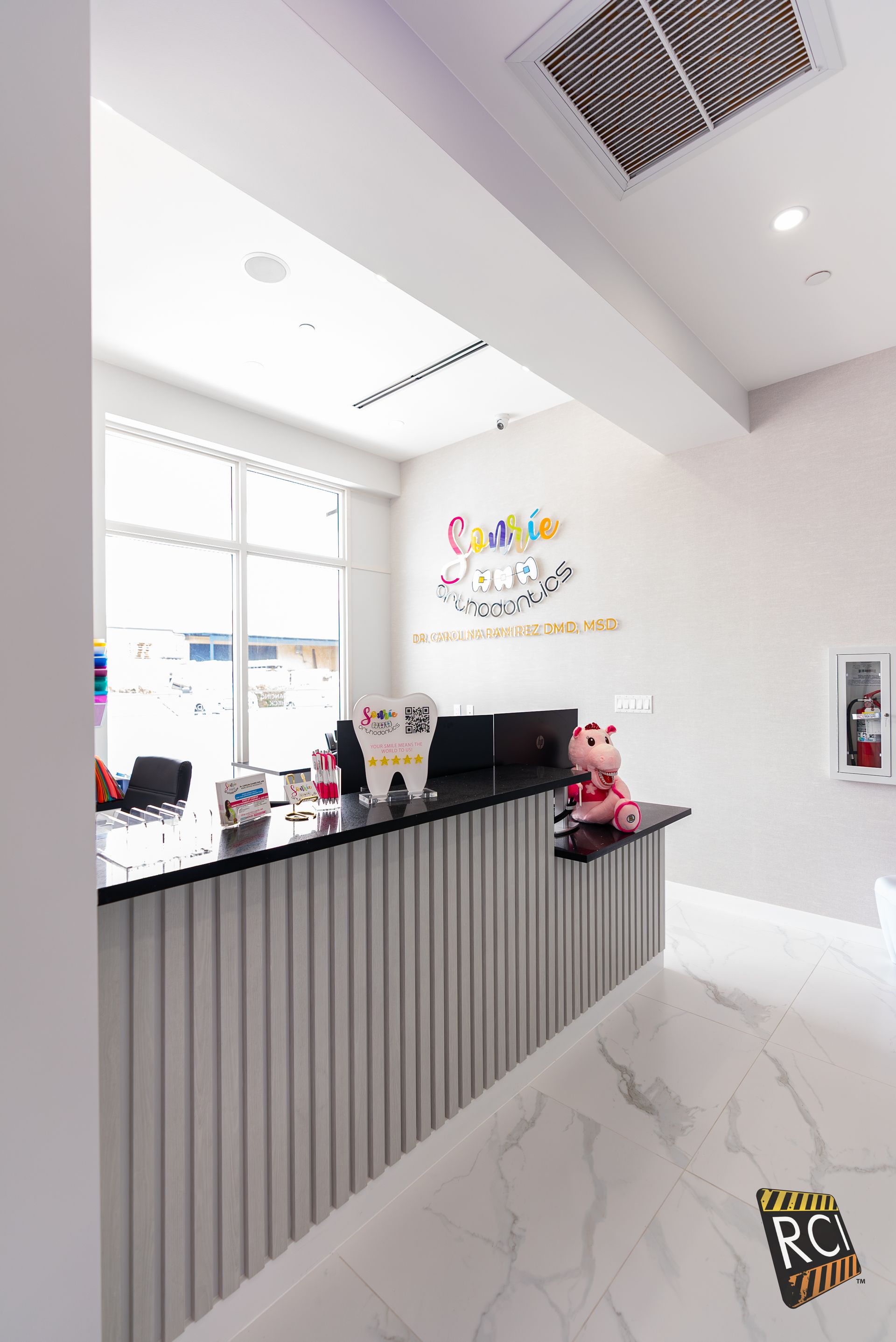 A reception desk in a room with a large window.