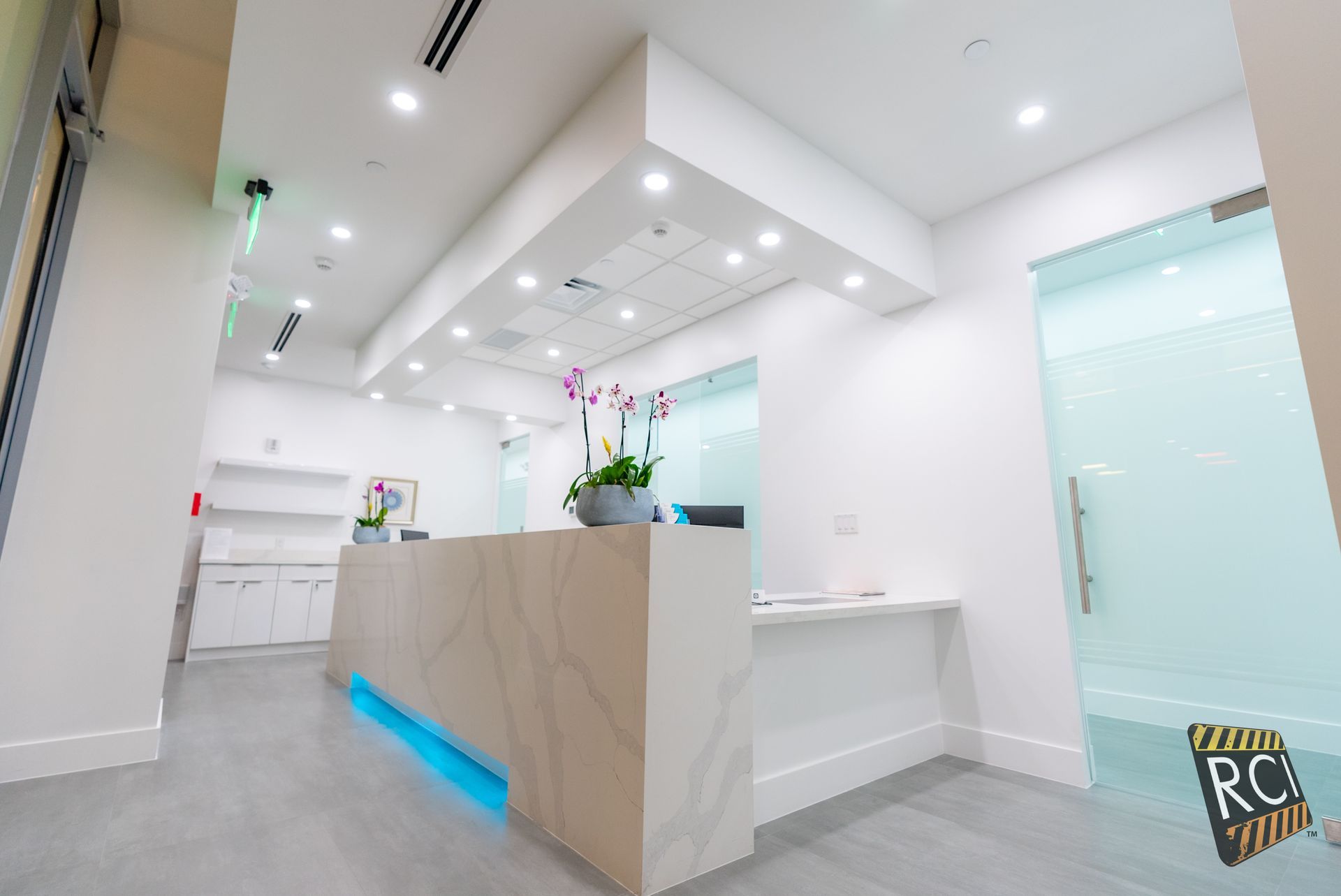 A reception desk in a dental office with a blue light on it.