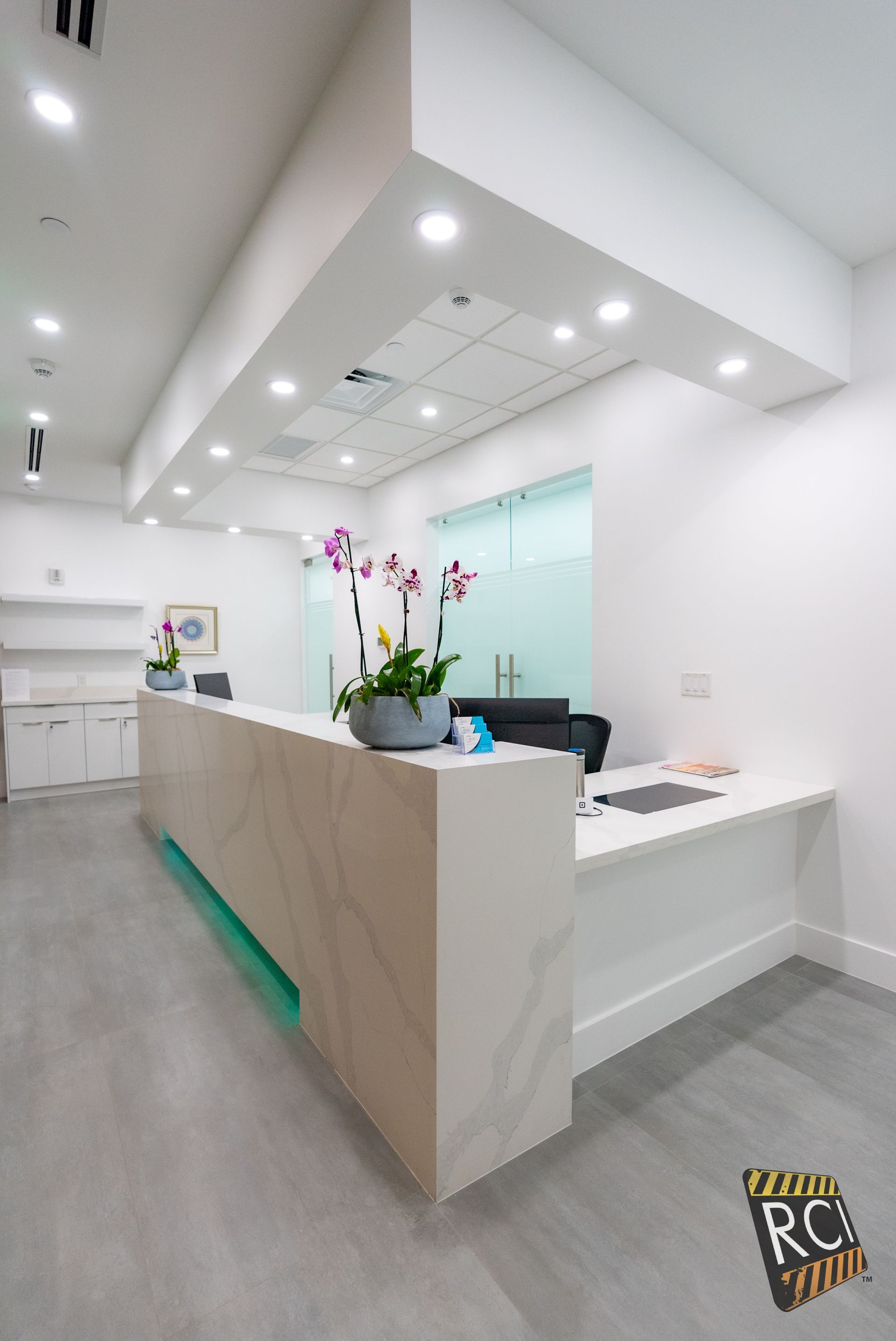 A long white counter in a room with flowers on it