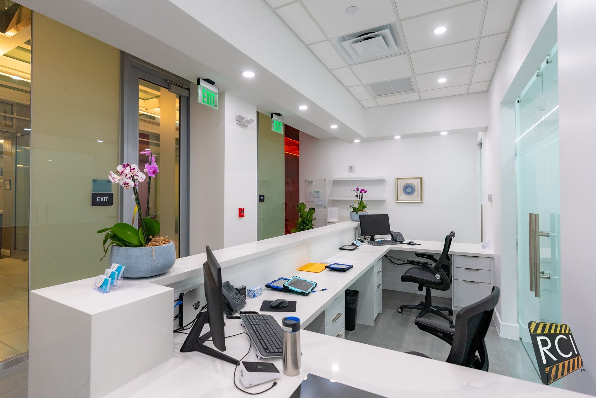 A dental office with a reception desk and chairs.