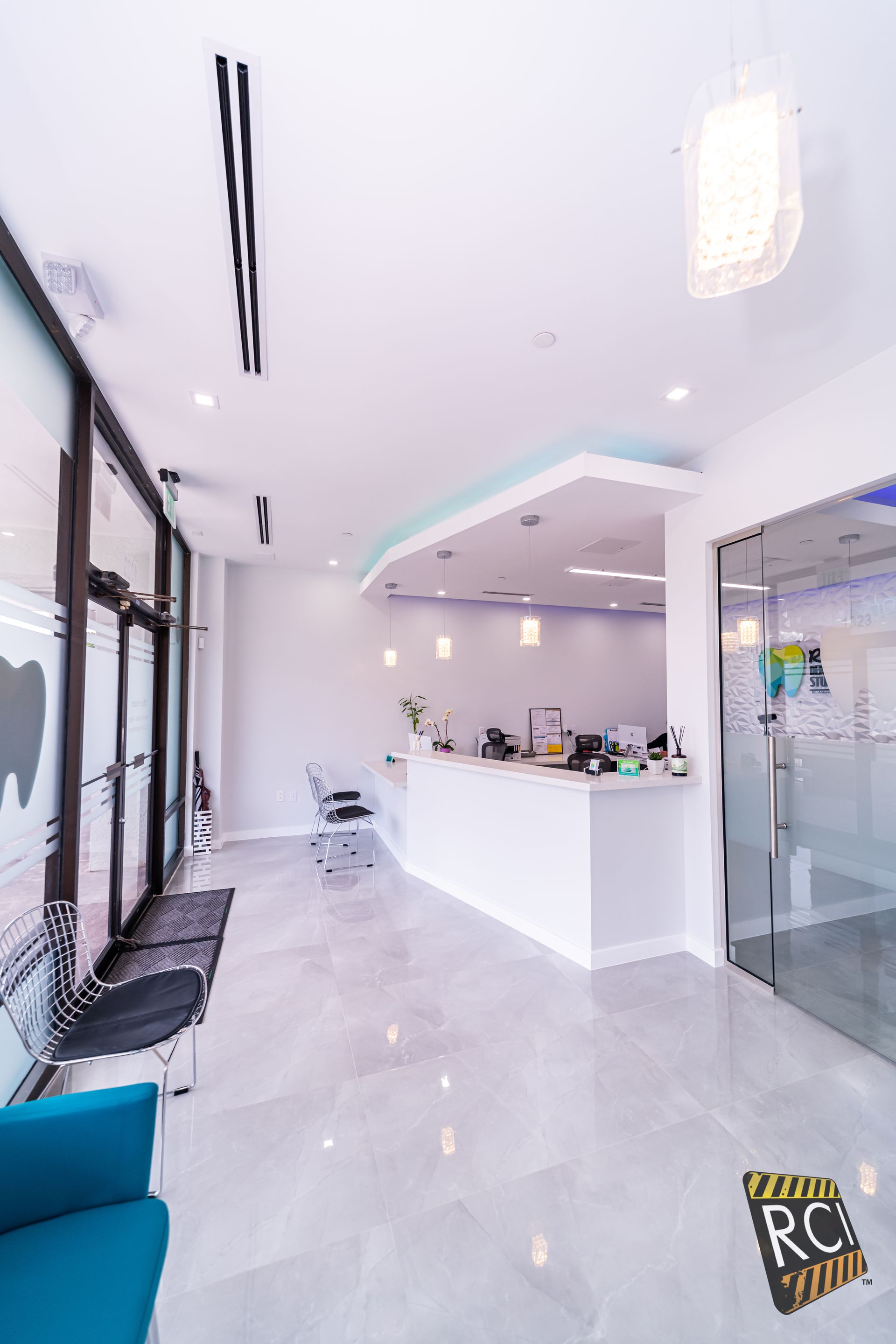 A dental office with a waiting room and a reception desk.