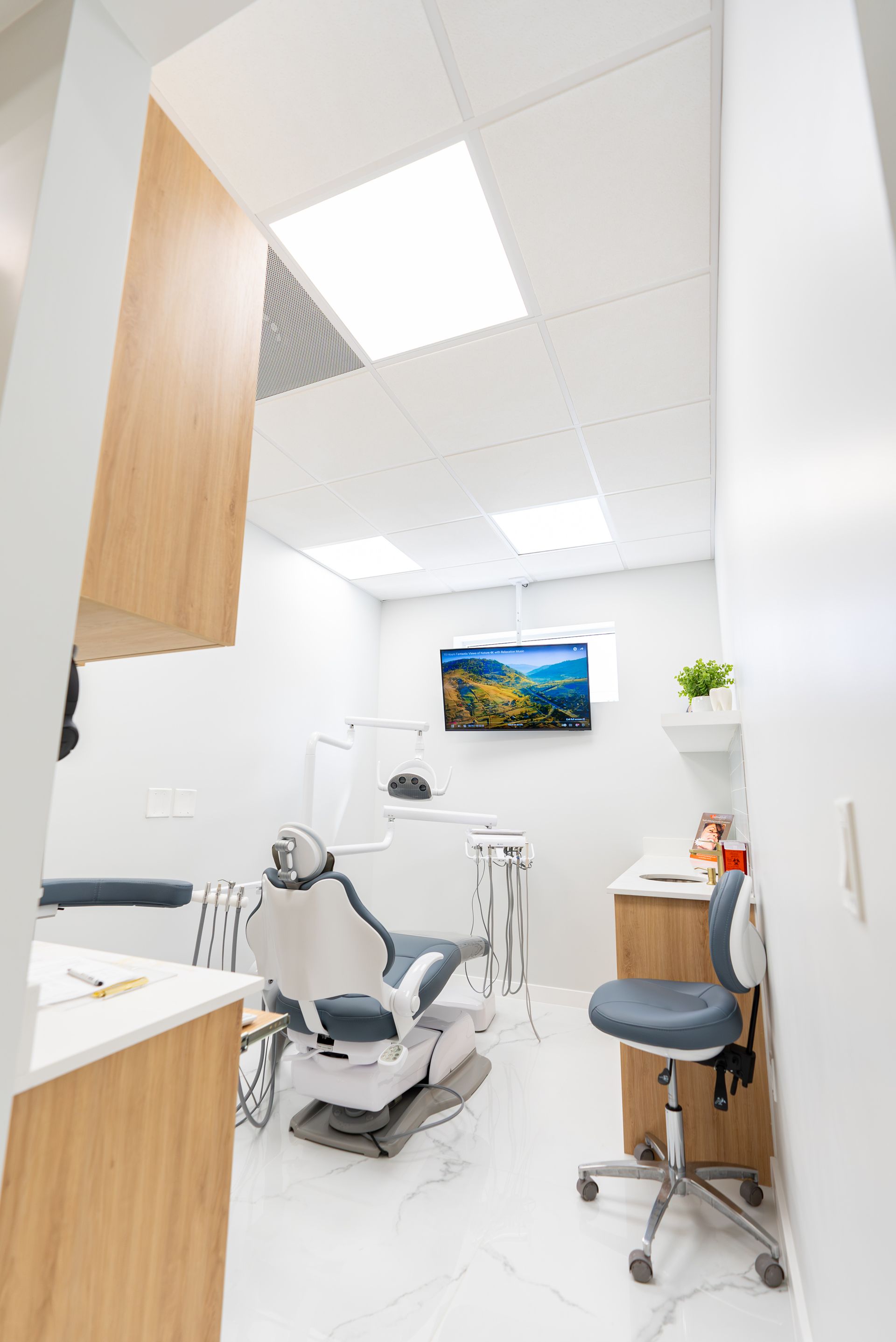 A dental office with a dental chair and a desk.