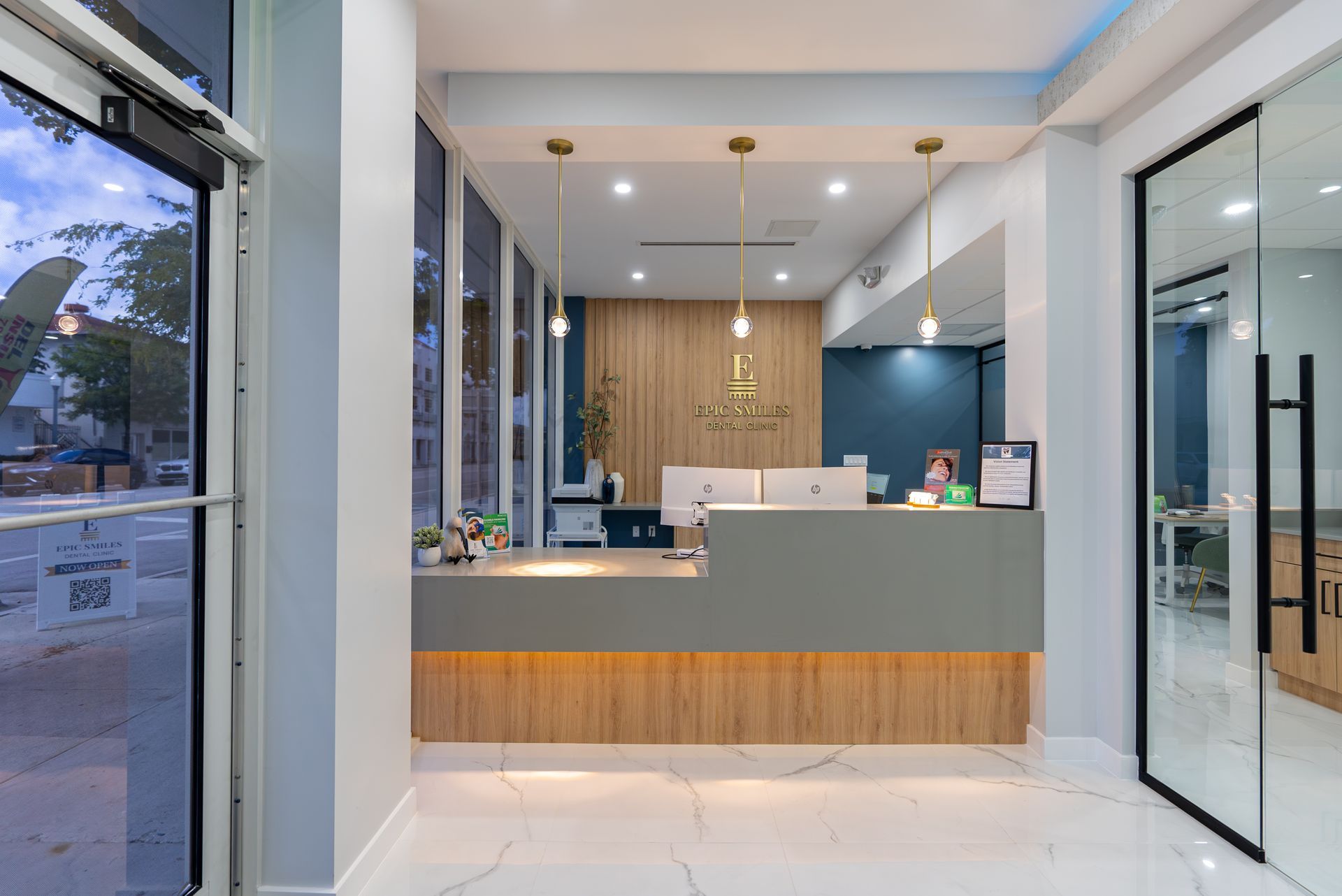 A dental office with a reception desk and a glass door.