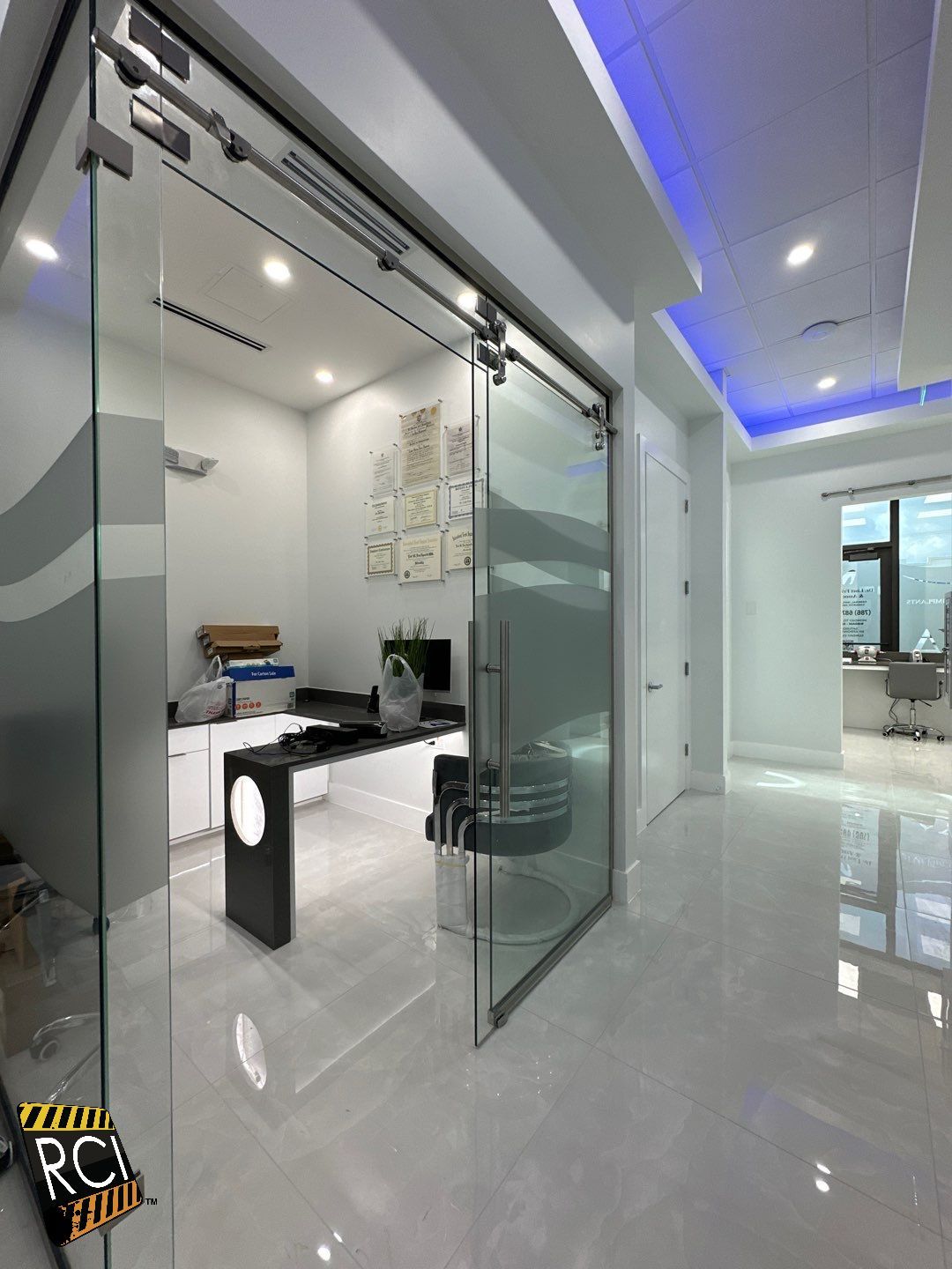 A room with a sliding glass door and a desk in it.