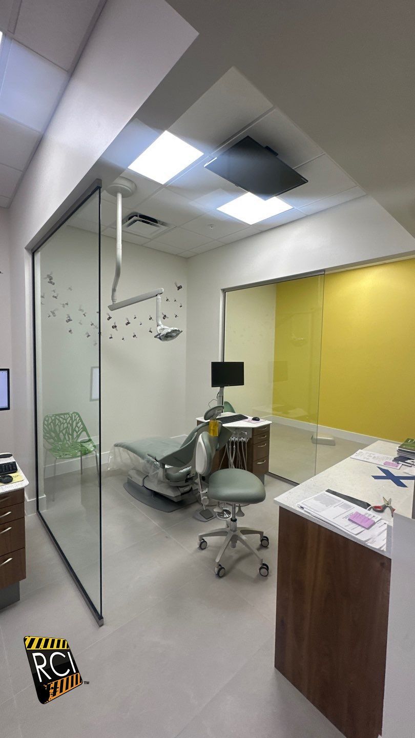 A dental office with a dental chair and a desk.
