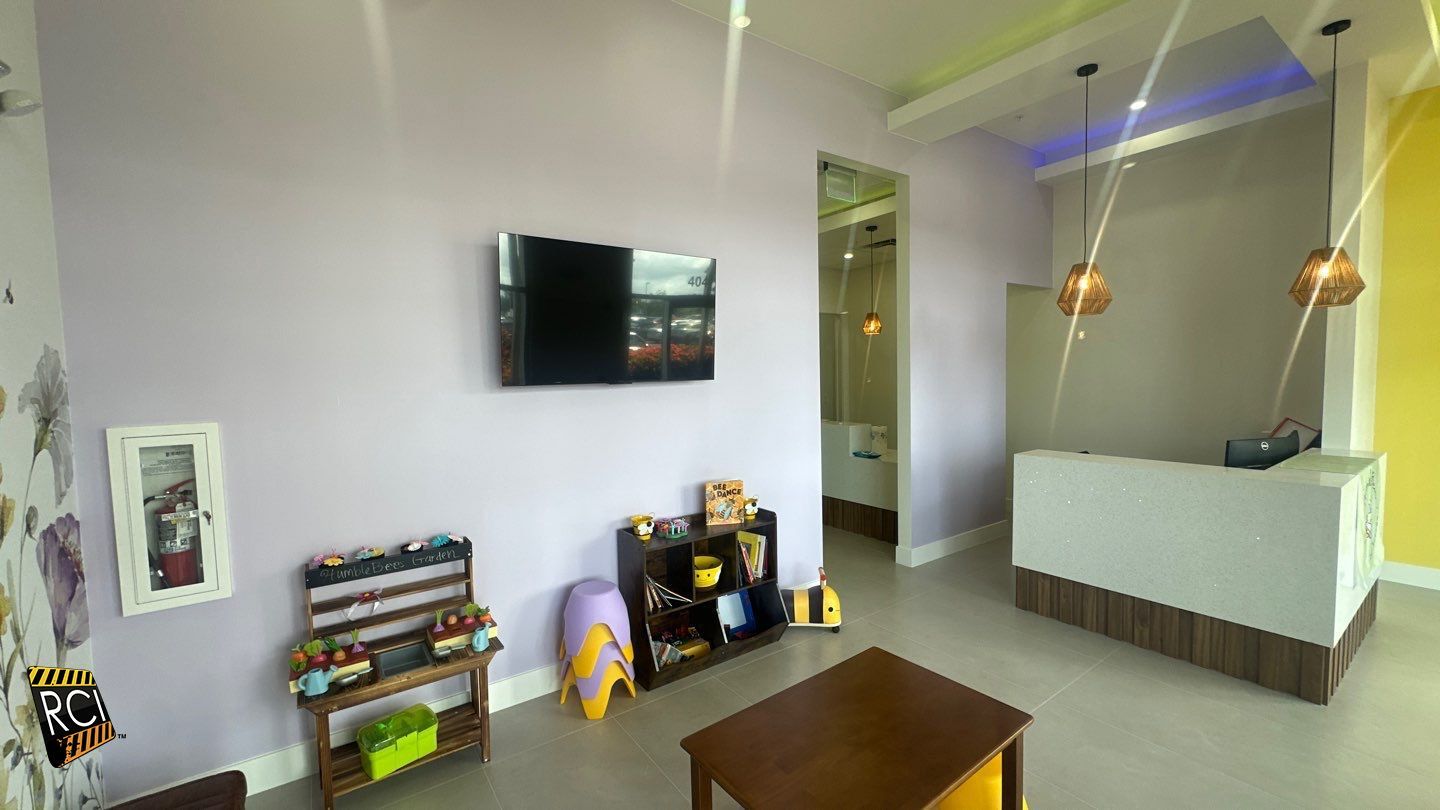 A living room with a table , television , and toys.