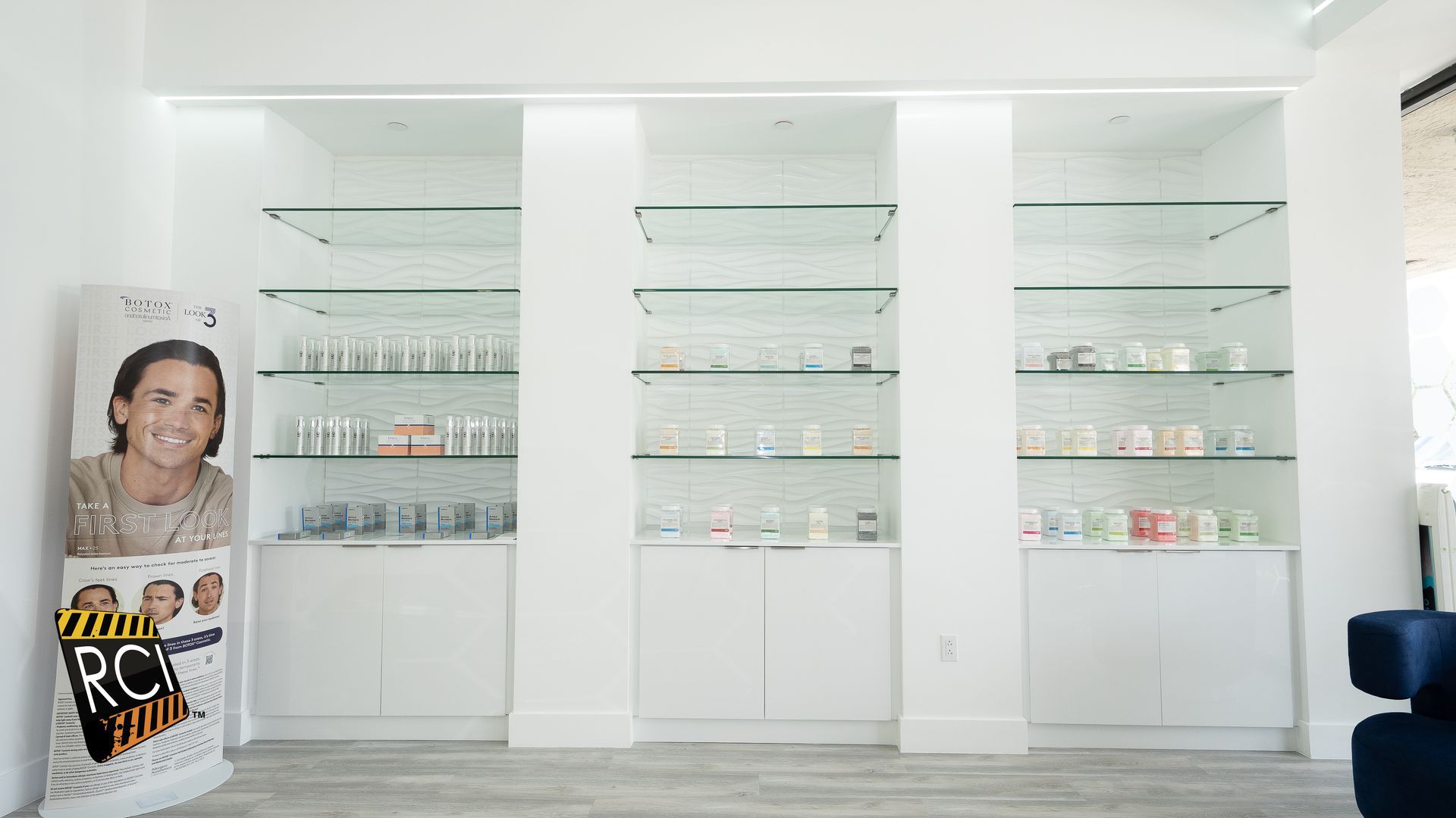 A room with a lot of shelves and a sign on the wall.