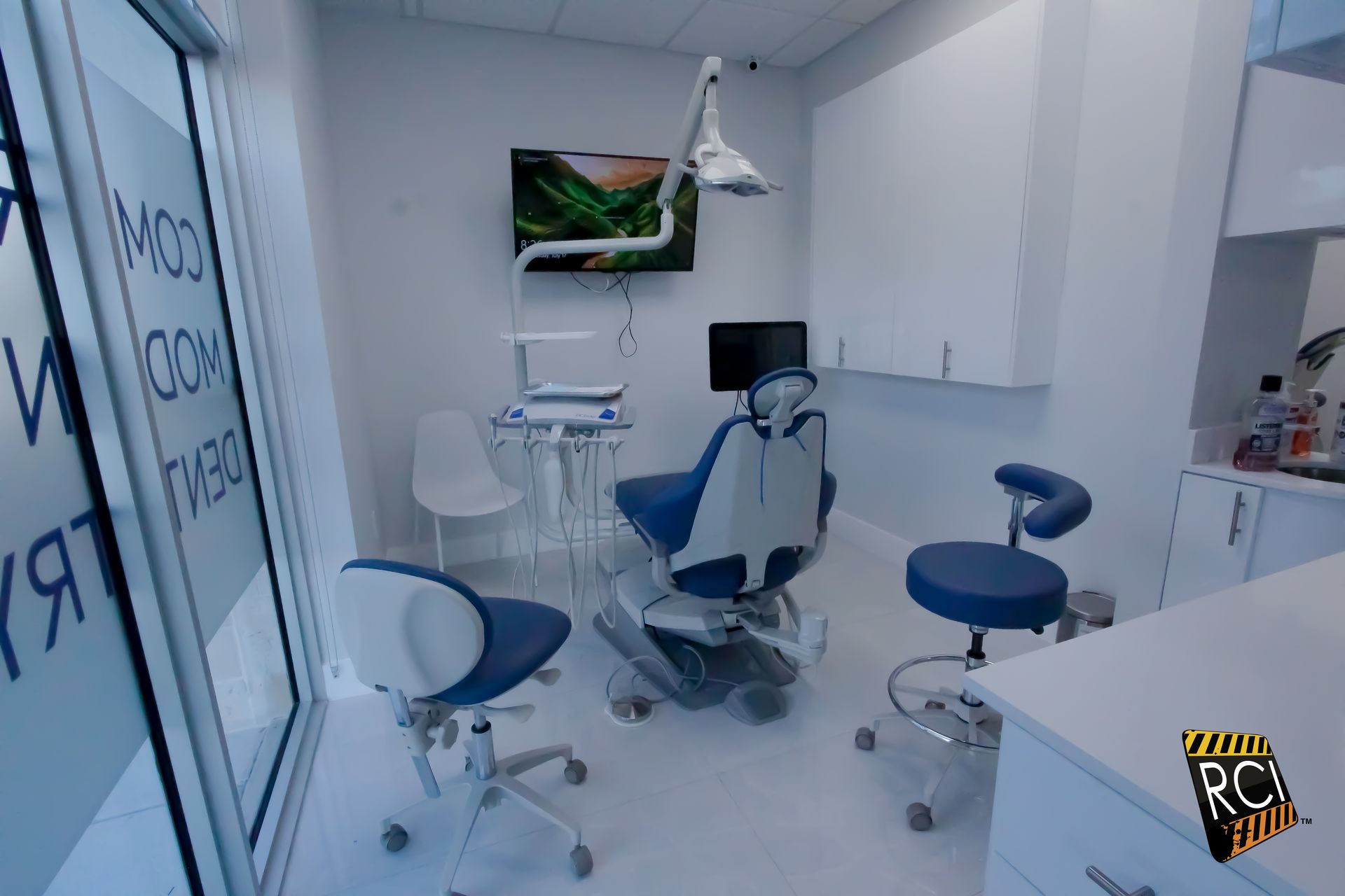 A dental office with a dental chair and chairs