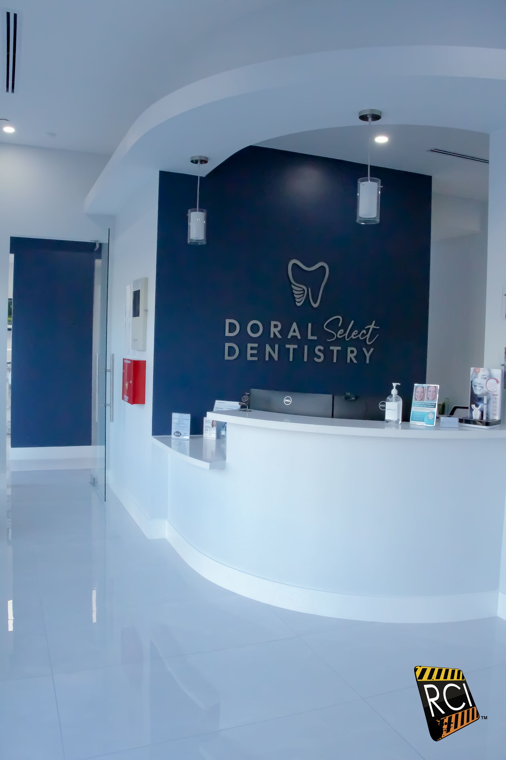A dental office with a blue wall and a white counter