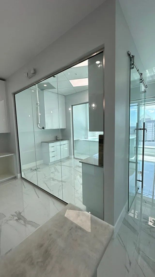 A room with a glass wall and a table in it.
