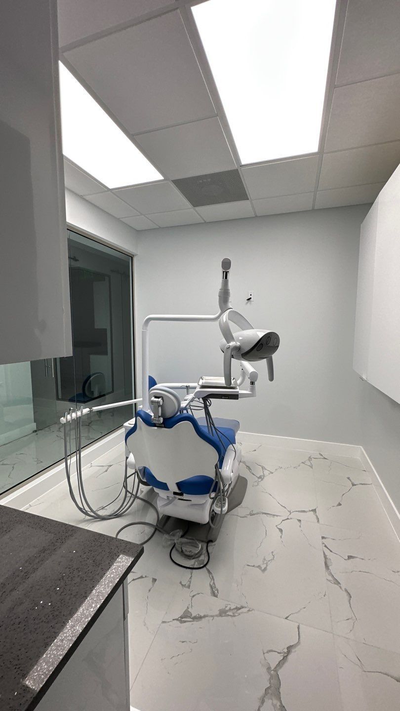 A dental office with a dental chair and a dental light.