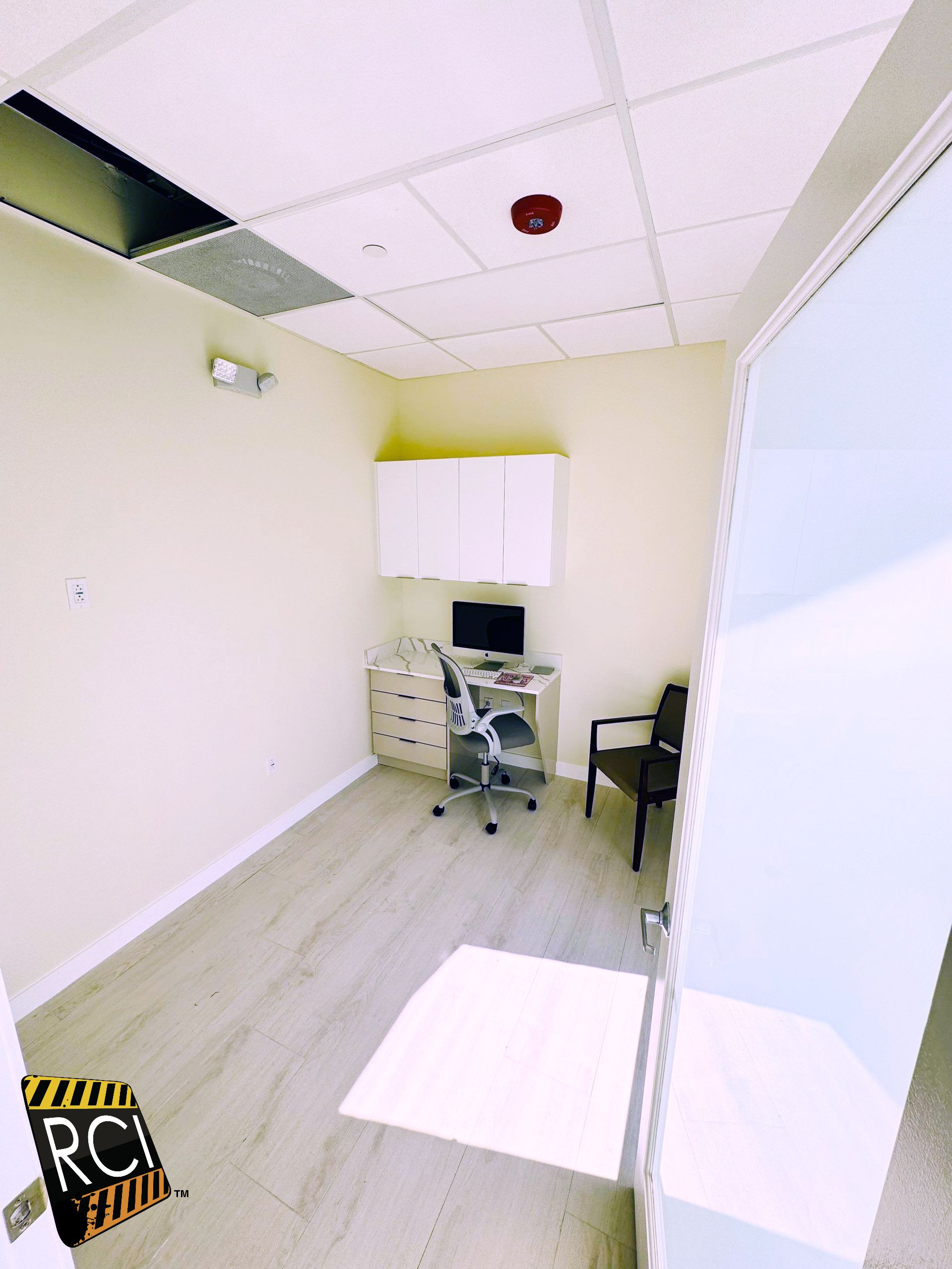 A small room with a desk and chair in it