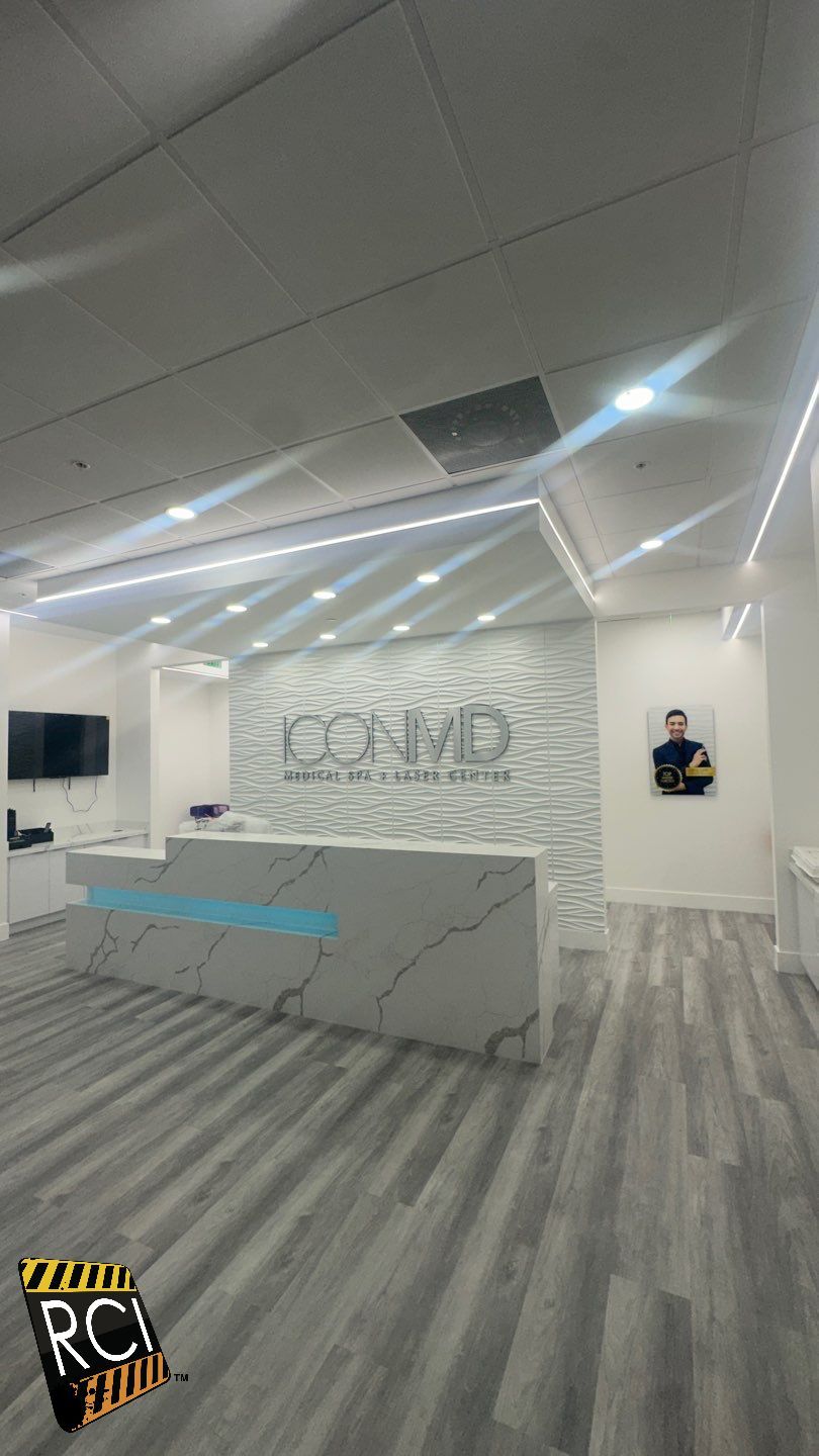 A reception area with a white counter and a gray floor.