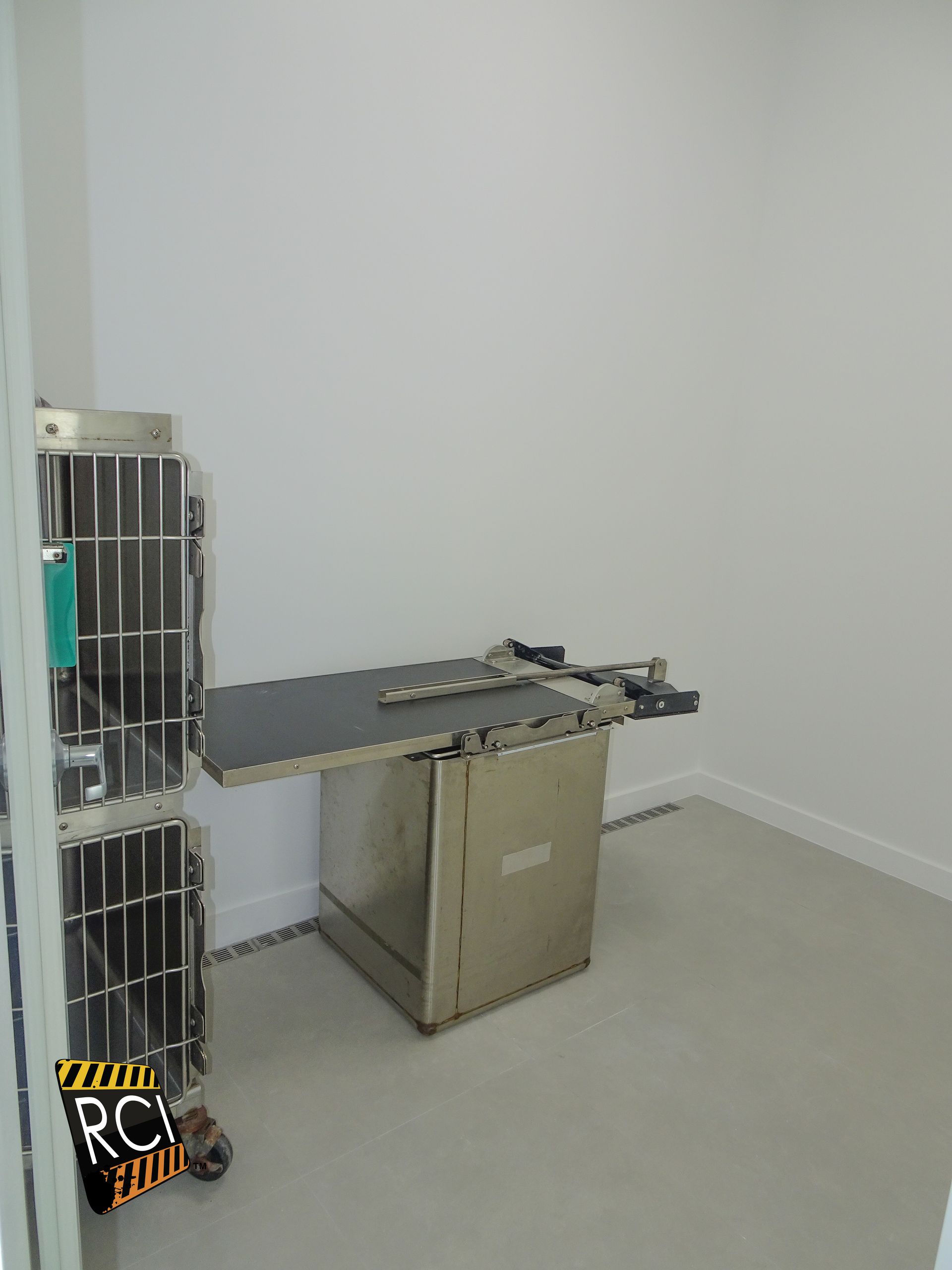 A room with a table and a cage in it