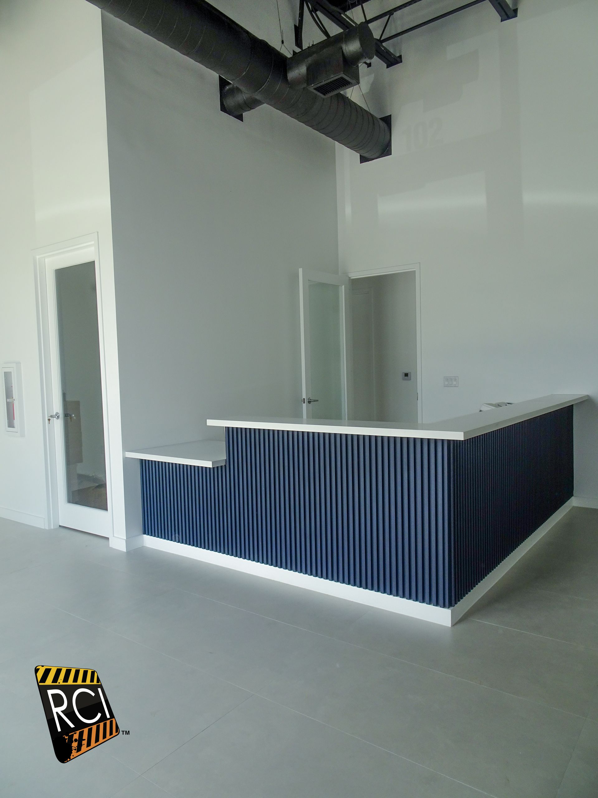 An empty room with a blue counter in the middle