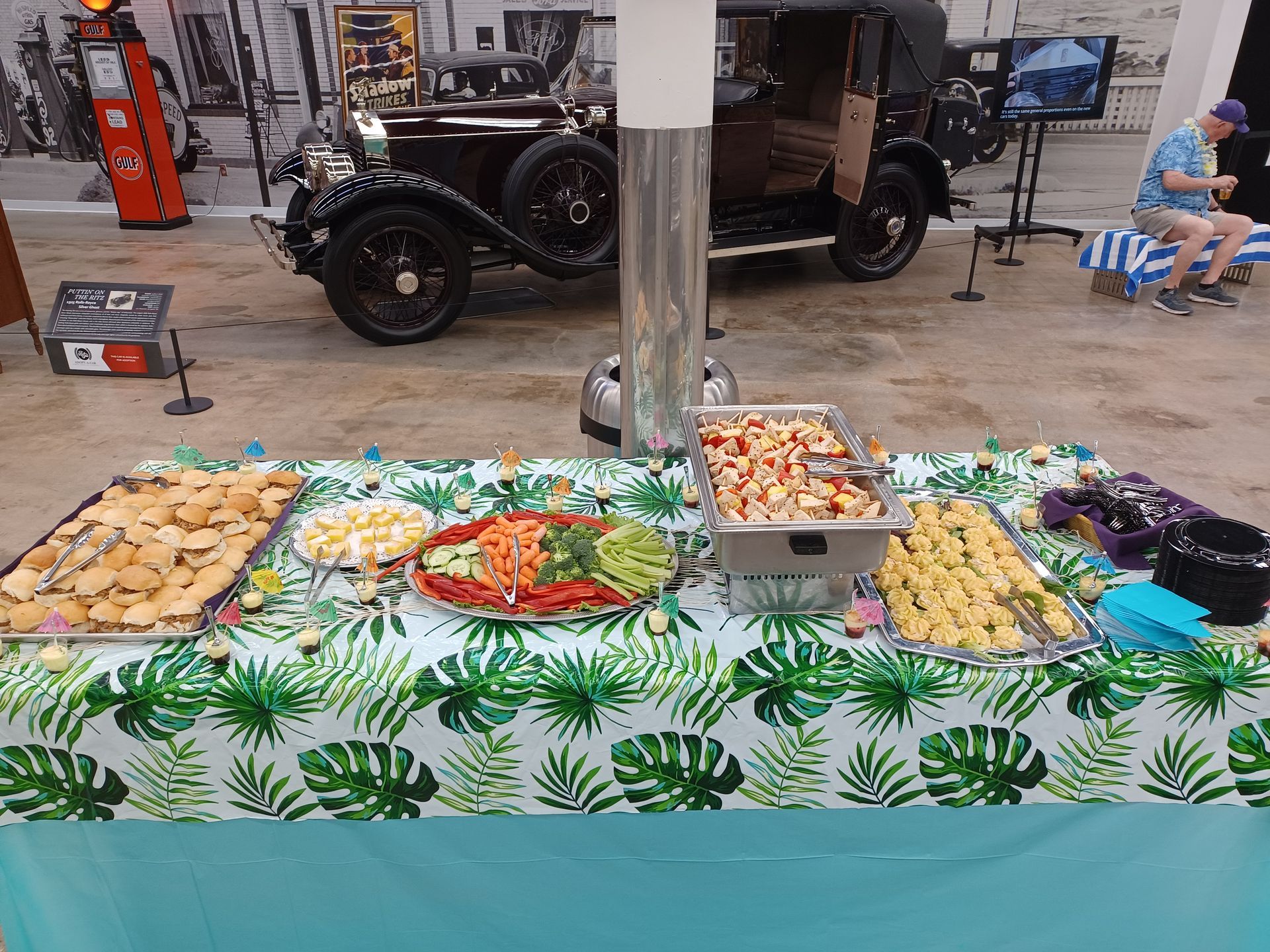 a table with a lot of food on it and a car in the background