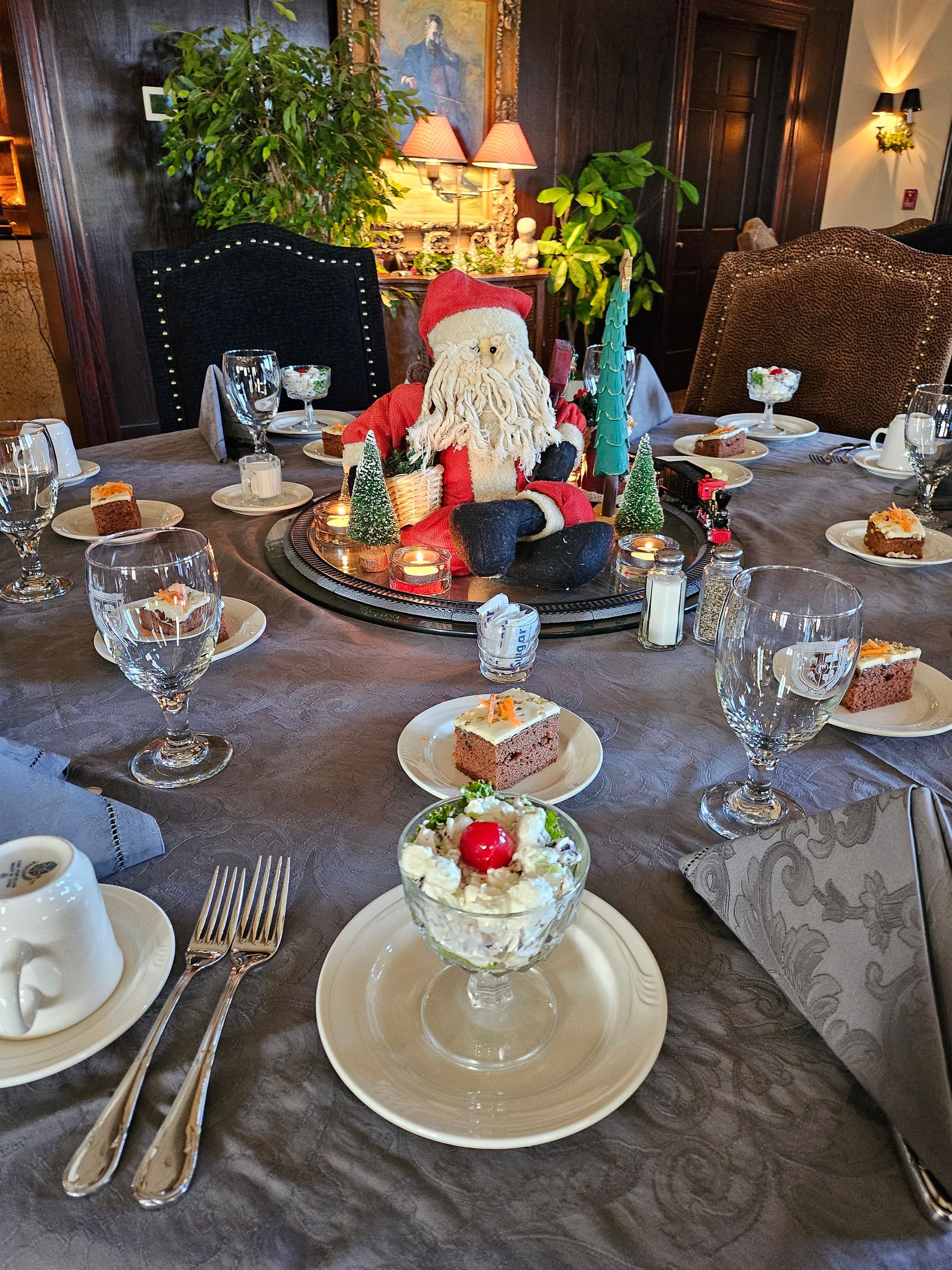 a table set for a Christmas dinner with Santa Claus on it