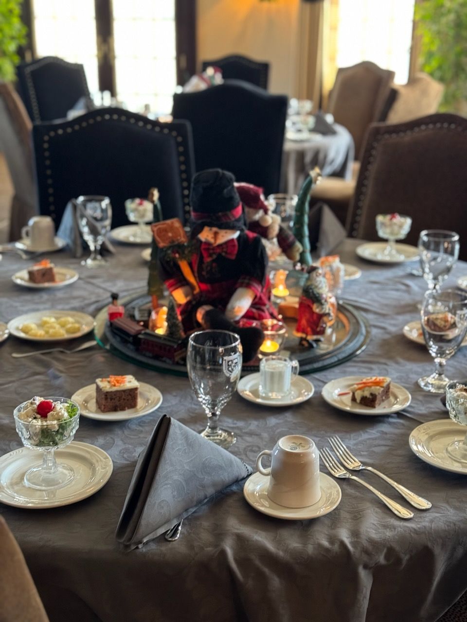 a table set for a Christmas dinner with a snowman on it