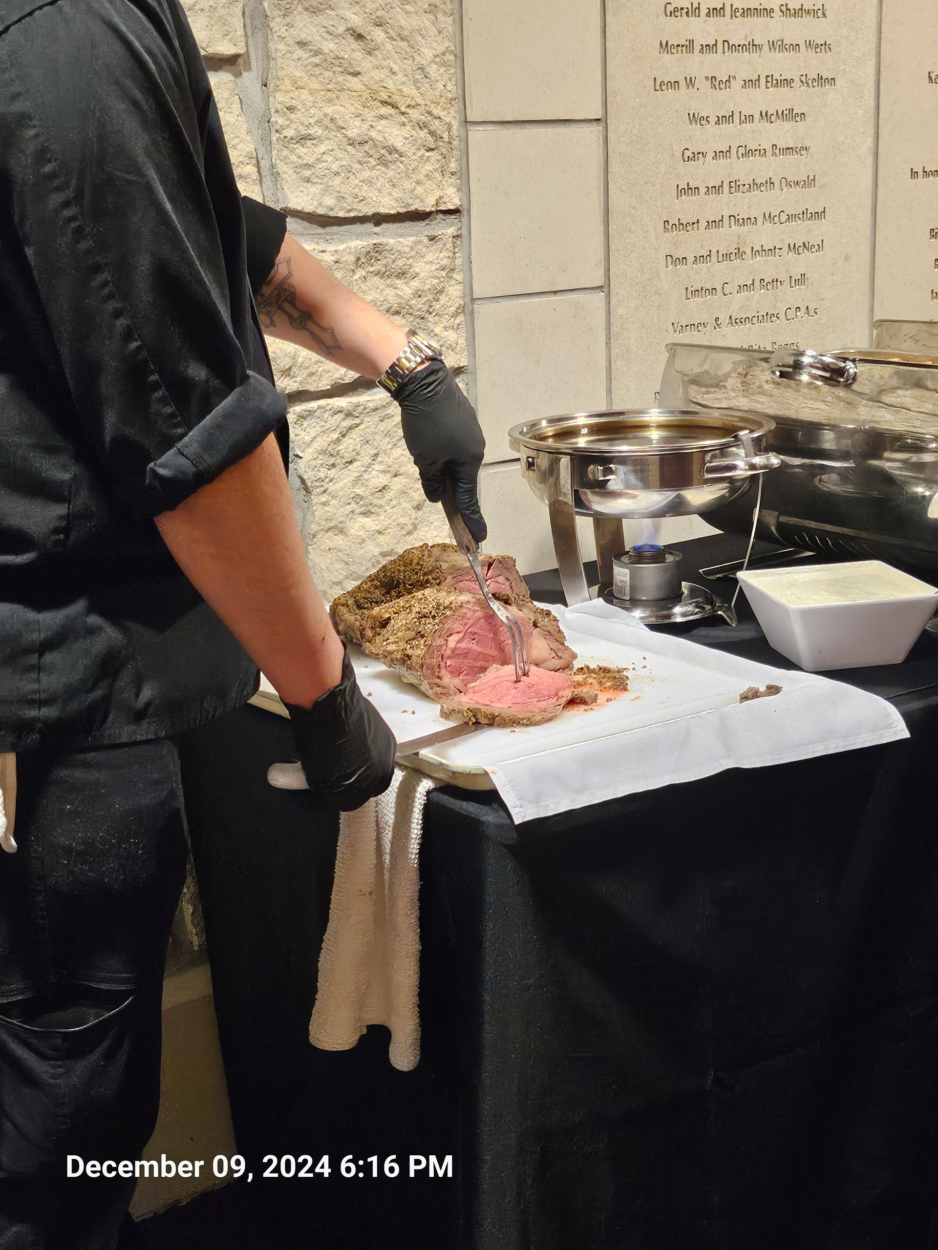 A man is cutting a piece of meat on a cutting board.