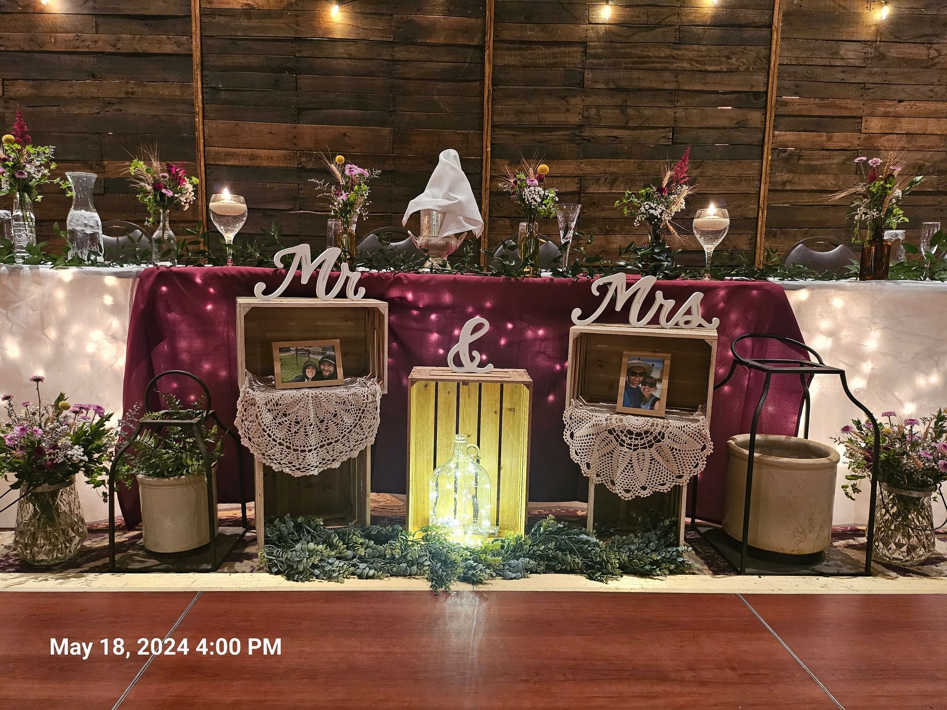 A table with a purple table cloth and a sign that says Mr. and Mrs.