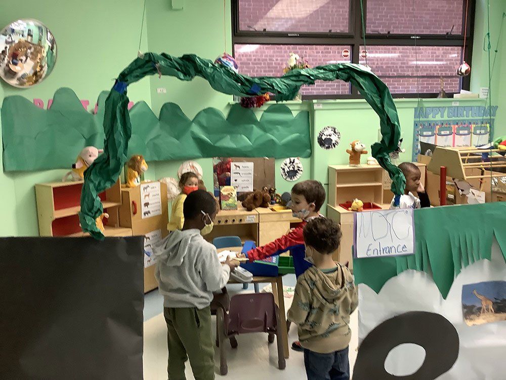 A group of children are playing in a classroom