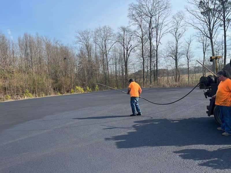 Workers paving a parking lot