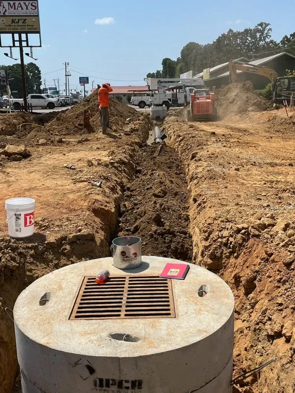 A man is standing in the dirt near a sign that says always