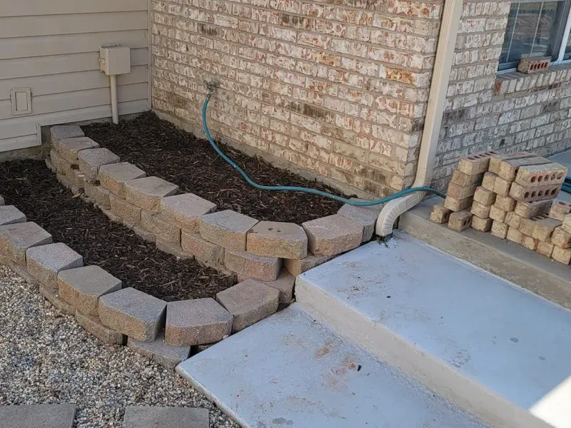 A brick wall with a hose attached to it