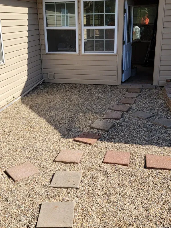 A house with a walkway leading to it and a window.