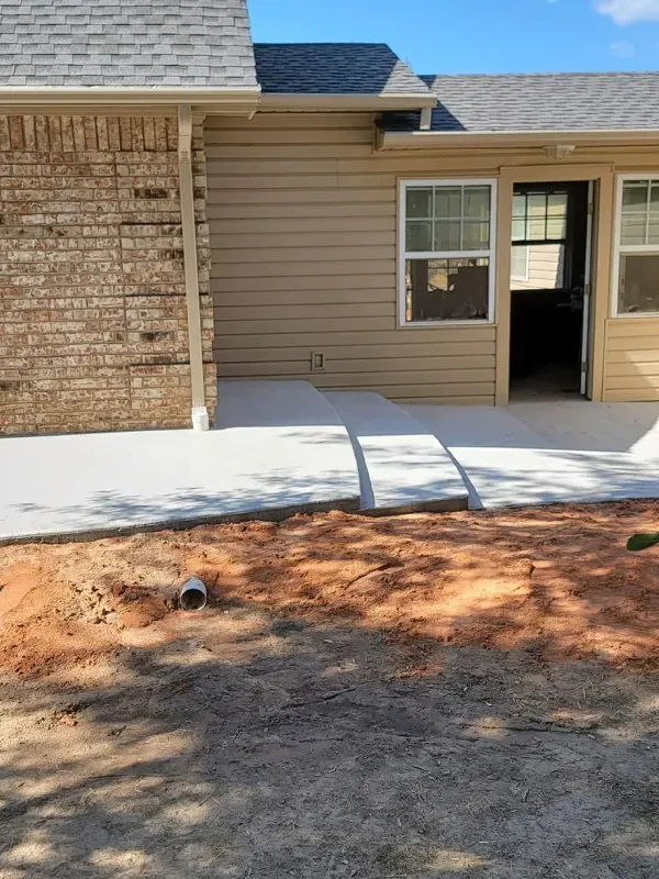 A house with a concrete walkway in front of it