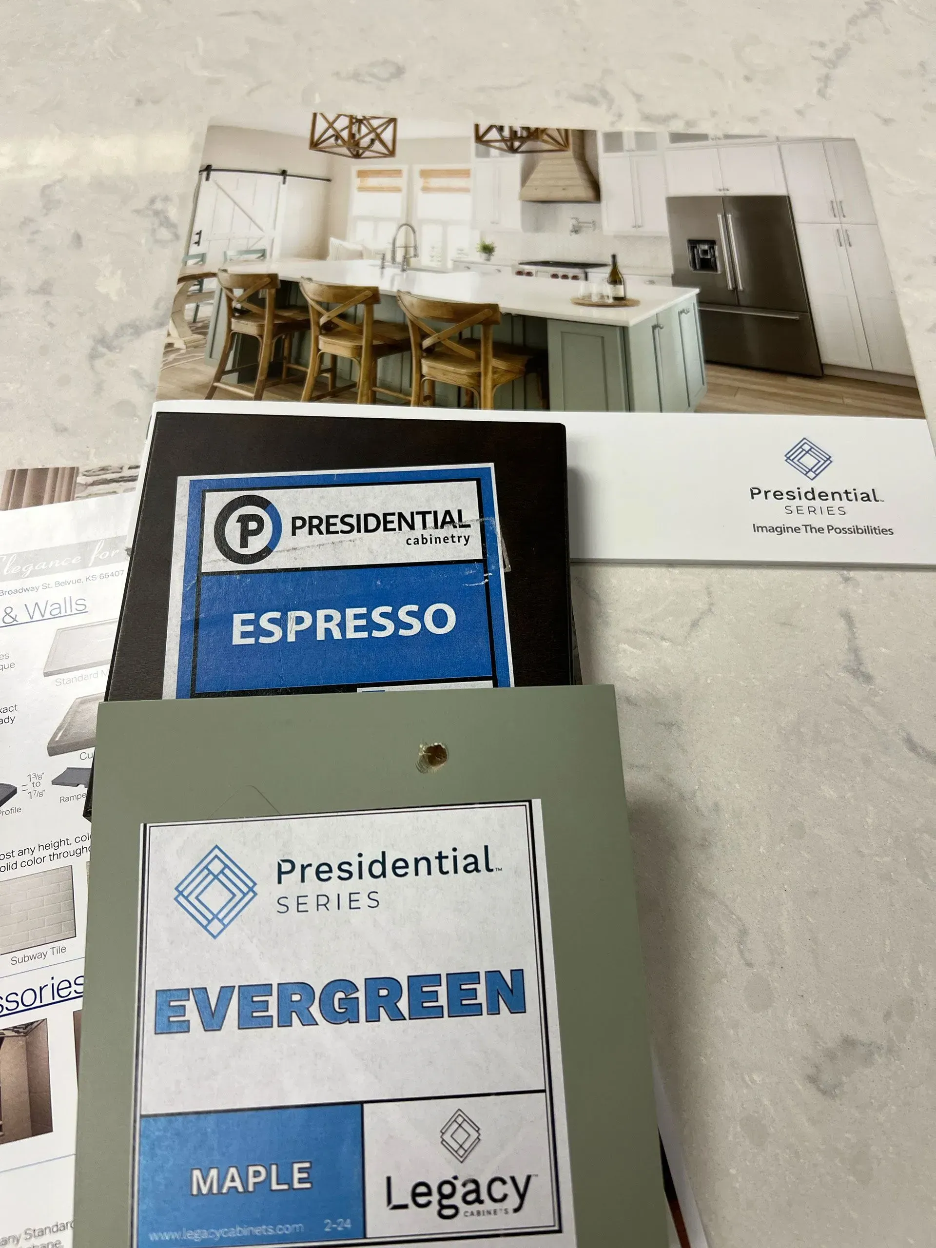 Coffee pods on a countertop beside a brochure showing a bright kitchen or café interior.
