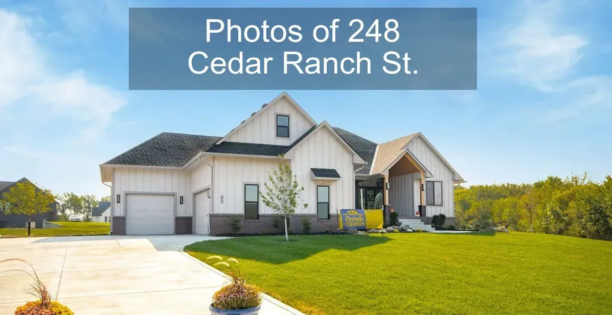 White house with a three-car garage and green lawn; text reads “Photos of 248 Cedar Ranch St.”