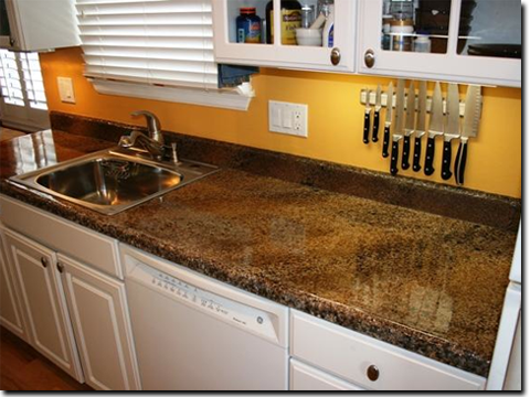 A kitchen with a sink and knives hanging on the counter