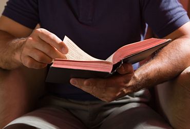 Man reading religious books