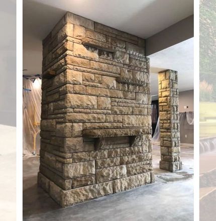 Stone pillars and wall in an interior setting. Light brown stone with recessed details.