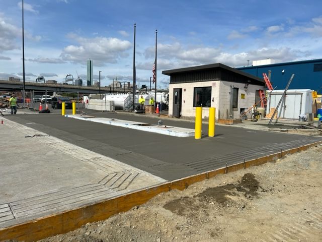 A building with yellow poles and a building in the background