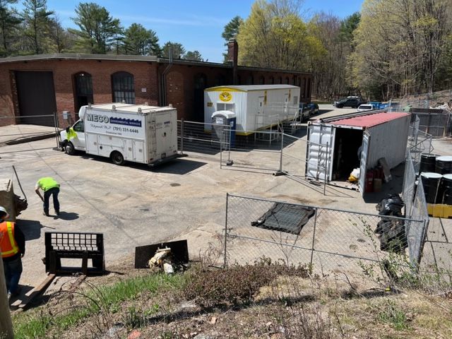 A group of men standing next to a building